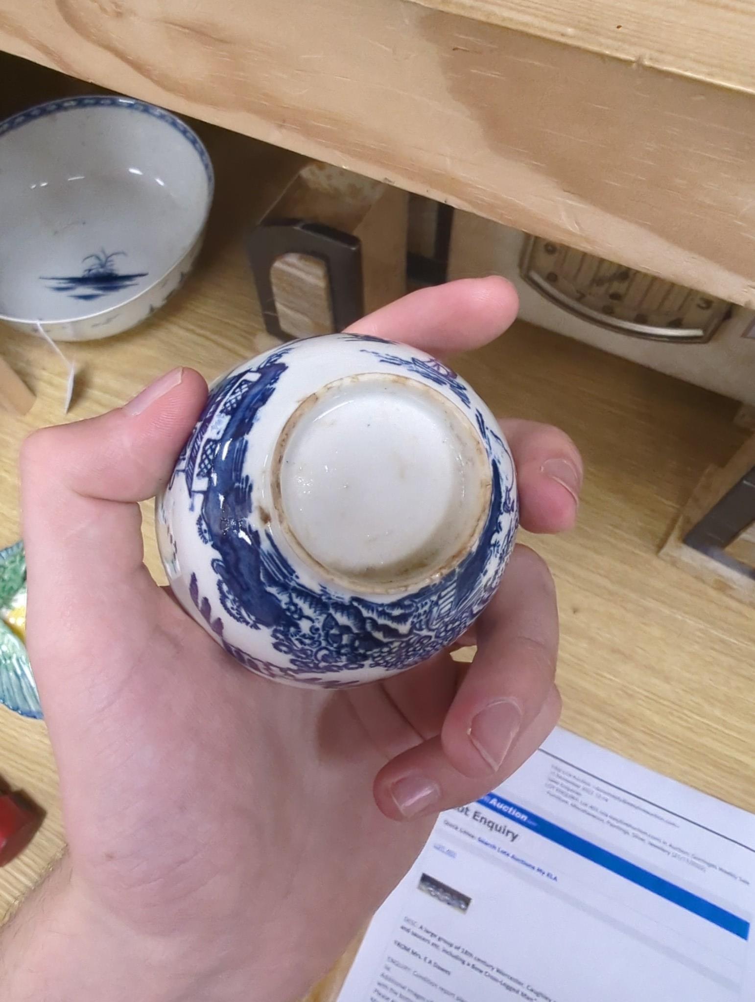 A large group of 18th century Worcester, Caughley and Liverpool blue and white tea bowls, coffee cups and saucers etc. including a Bow Cross-Legged Man